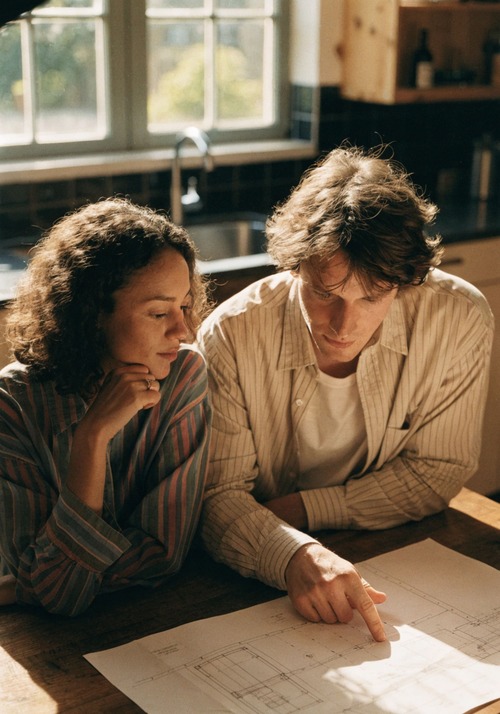 couple-reviewing-house-blueprint
